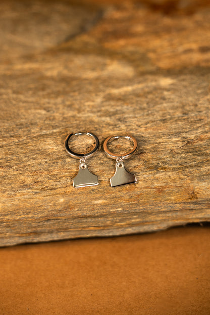 Silver hoop earrings with cattle tag pendants